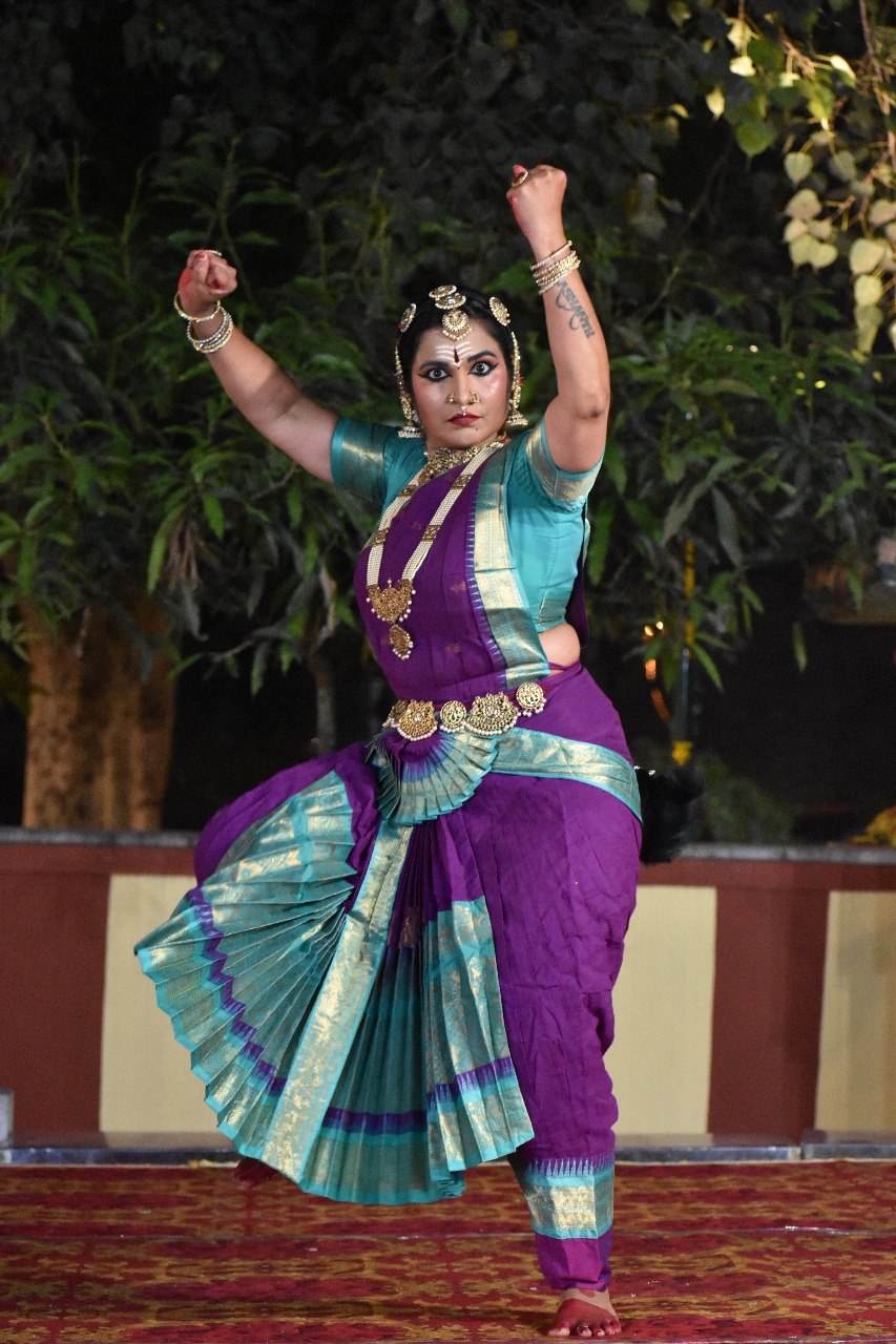 Smt. Pooja Raj mid-performance under stage light