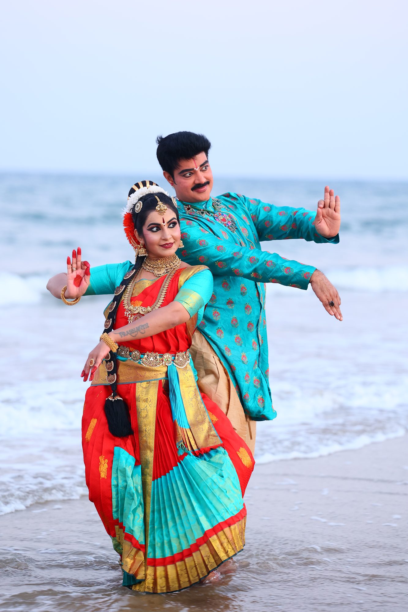 Guru Dr. Sanjay Shantaram and Smt. Pooja Raj dancing together at the shore